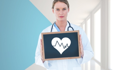 Portrait of doctor holding a slate board in hallway