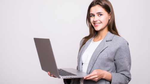 Young female working on laptop isolated on white background